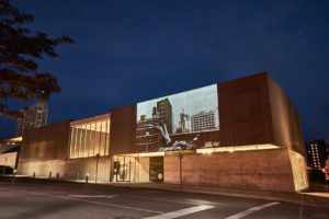 View of Tim Portlock: 11th_st_city_symphony.mp4 projected on CAM's facade