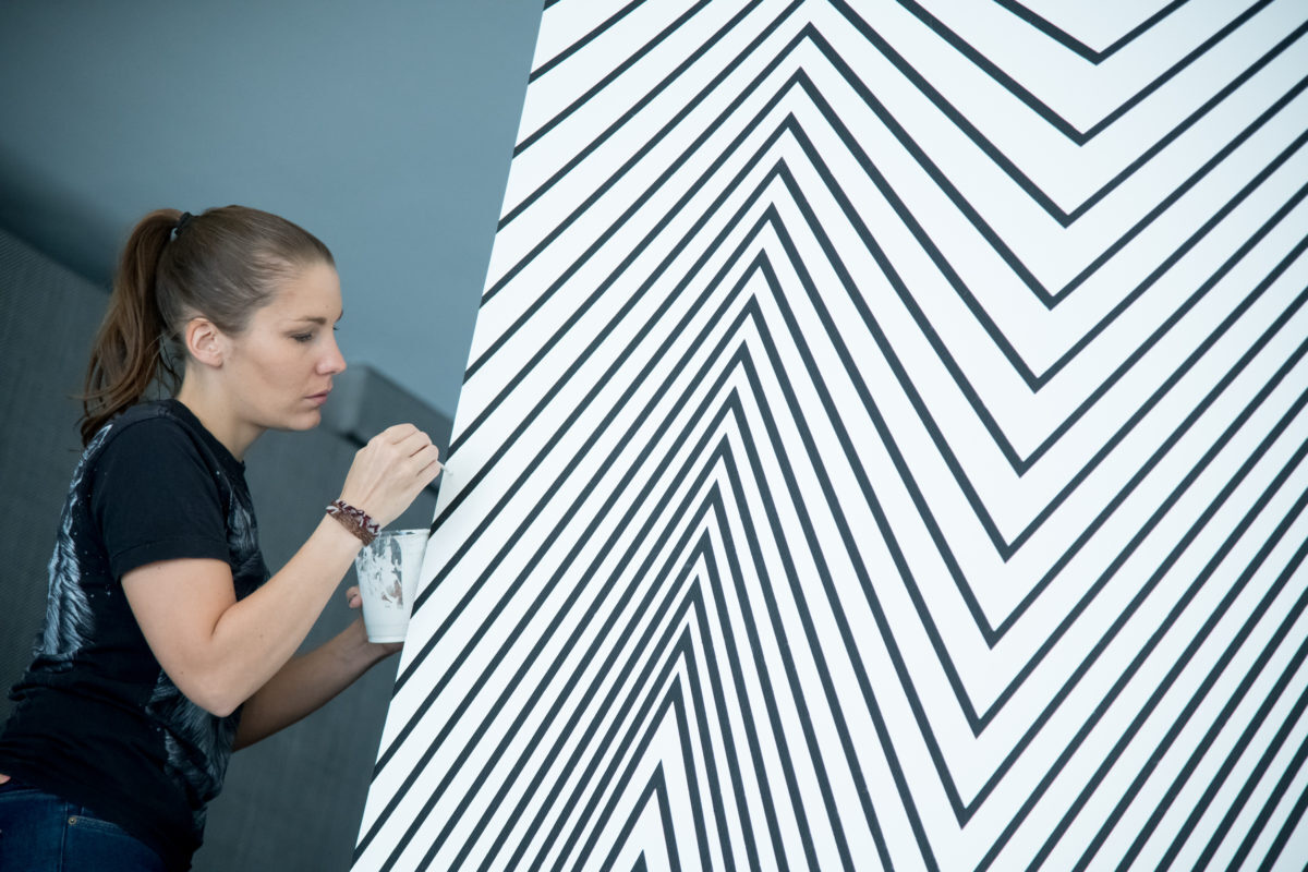Claudia Comte at work on <em>Electric Burst (Lines and Zigzags)</em>. Photo: Jon Gitchoff.