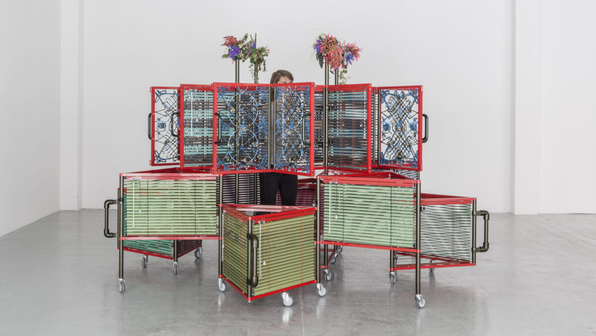 Haegue Yang, <i>Dress Vehicle – Yin Yang</i>, 2012. Aluminum venetian blinds, powder-coated aluminum frame, powder-coated handles, casters, magnets, knitting yarn, bells, elastic cord. 221 x 310 x 310 cm. Collection M+, Hong Kong. Installation view of <i>Haegue Yang: Ajar</i> at La Douane, Galerie Chantal Crousel, Paris, France, 2012. Photo: Florian Kleinefenn.