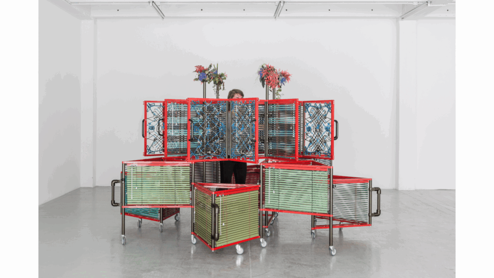 Haegue Yang, <i>Dress Vehicle – Yin Yang</i>, 2012. Aluminum venetian blinds, powder-coated aluminum frame, powder-coated handles, casters, magnets, knitting yarn, bells, elastic cord, 221 x 310 x 310 cm. Collection of M+, Hong Kong. Installation view of <i>Haegue Yang: Ajar</i>, La Douane, Galerie Chantal Crousel, Paris, France, 2012. Photo: Florian Kleinefenn.